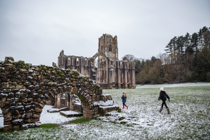 An image of Fountains Abbey in the snow